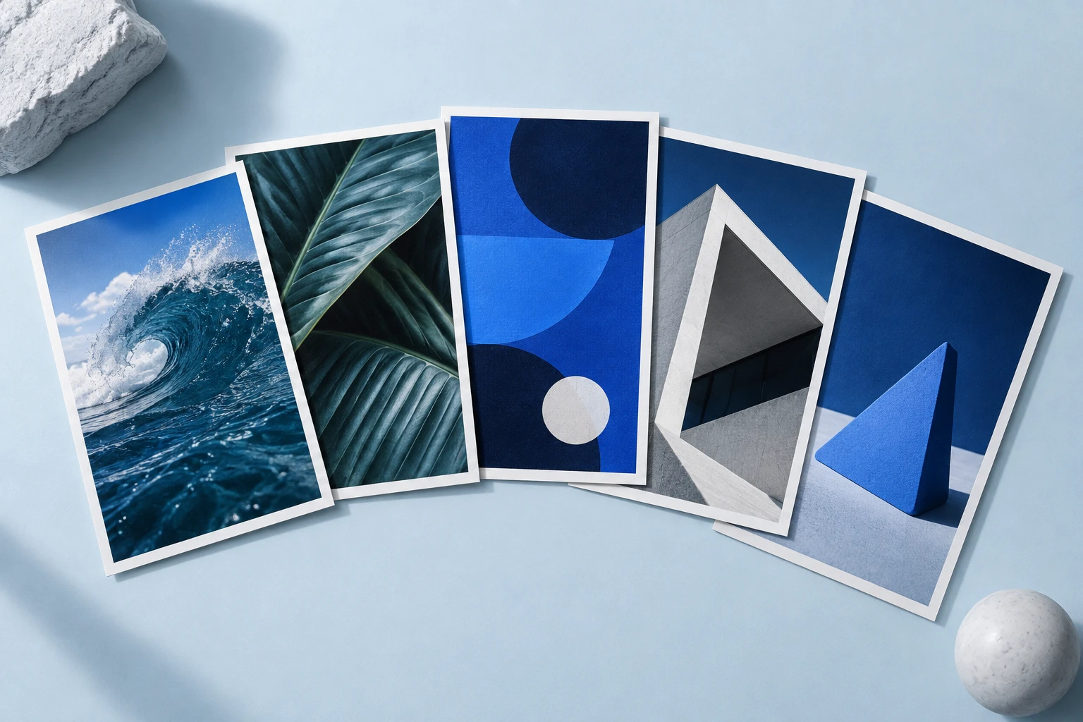 An editorial arrangement of vertical creative prints in Prolifik blue, with ocean, nature and architectural imagery.