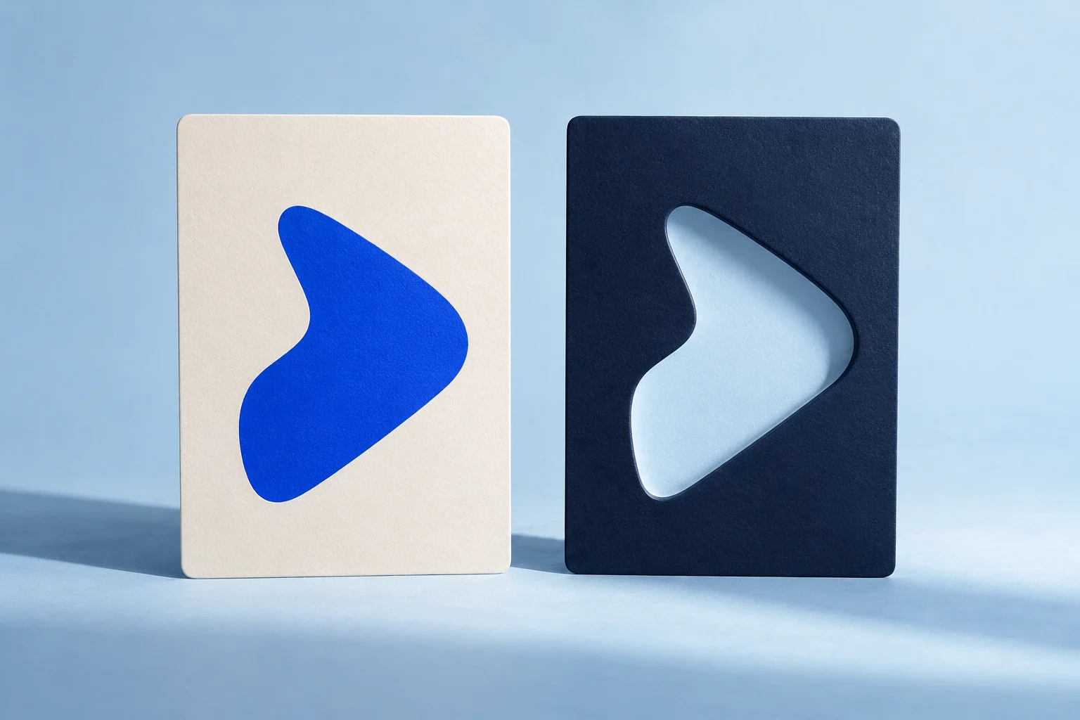 Two upright cards pair a cobalt shape with its matching cutout.
